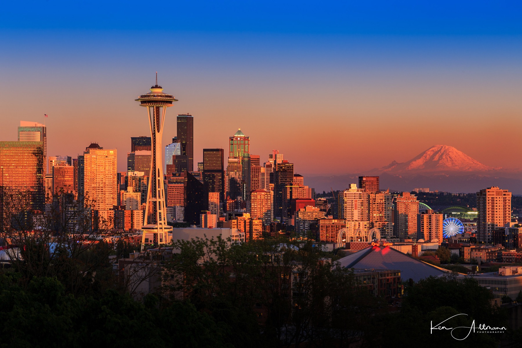 The Space Needle and Mount Rainier at sunset over the Seattle skyline